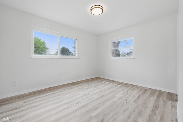 1116 Heatherwood Dr, Indianapolis, IN 46241 - spare room featuring baseboards and light wood-style floors