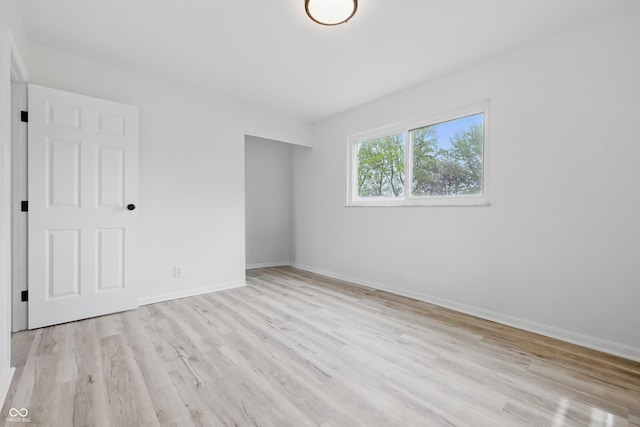 1116 Heatherwood Dr, Indianapolis, IN 46241 - unfurnished bedroom with baseboards and light wood-style flooring