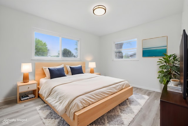 1116 Heatherwood Dr, Indianapolis, IN 46241 - bedroom featuring baseboards and light wood-type flooring