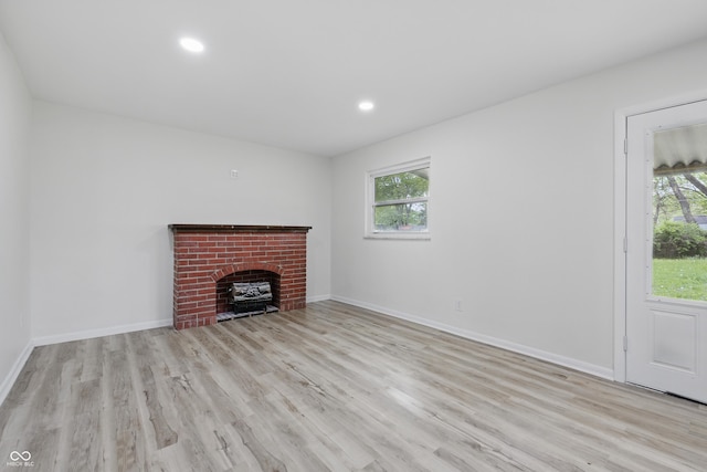 1116 Heatherwood Dr, Indianapolis, IN 46241 - unfurnished living room featuring a brick fireplace, recessed lighting, a wealth of natural light, and wood finished floors
