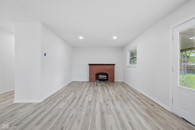 1116 Heatherwood Dr, Indianapolis, IN 46241 - unfurnished living room featuring a brick fireplace, recessed lighting, baseboards, and light wood-style floors