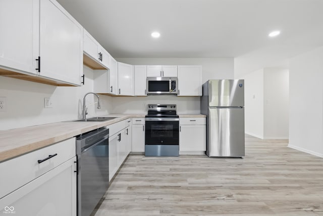 1116 Heatherwood Dr, Indianapolis, IN 46241 - kitchen with a sink, light countertops, stainless steel appliances, recessed lighting, and light wood-type flooring