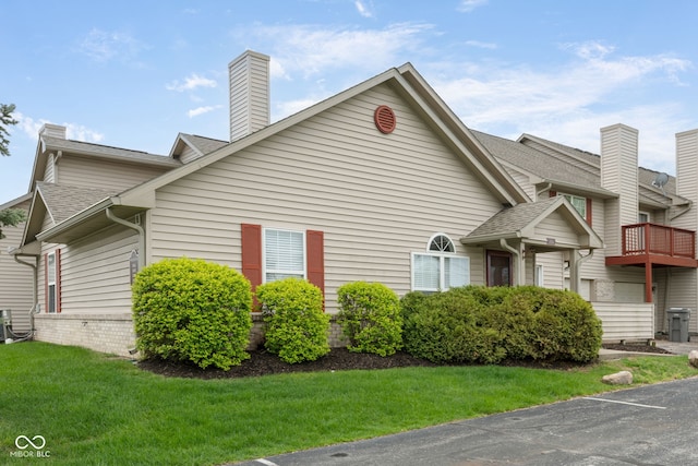 3006 Wildcat Ln, Indianapolis, IN 46203 - view of property exterior with a chimney, roof with shingles, and a lawn