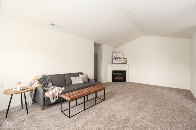 3006 Wildcat Ln, Indianapolis, IN 46203 - carpeted living room with vaulted ceiling, a glass covered fireplace, baseboards, and visible vents