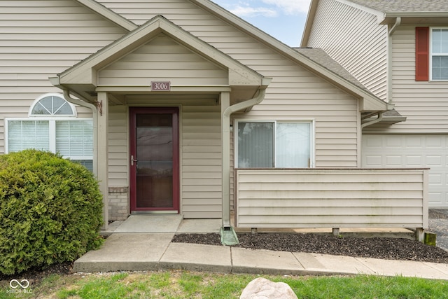 3006 Wildcat Ln, Indianapolis, IN 46203 - view of exterior entry featuring roof with shingles and a garage