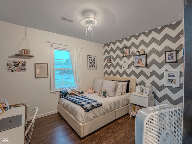 632 Woodside Ct, Seymour, IN 47274 - bedroom featuring baseboards, visible vents, wood finished floors, and an accent wall