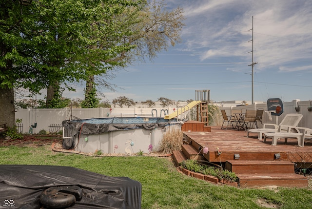 632 Woodside Ct, Seymour, IN 47274 - exterior space featuring a lawn, a deck, fence, and a fenced in pool
