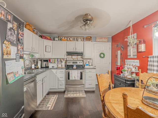 632 Woodside Ct, Seymour, IN 47274 - kitchen featuring appliances with stainless steel finishes, dark wood finished floors, a sink, under cabinet range hood, and white cabinetry