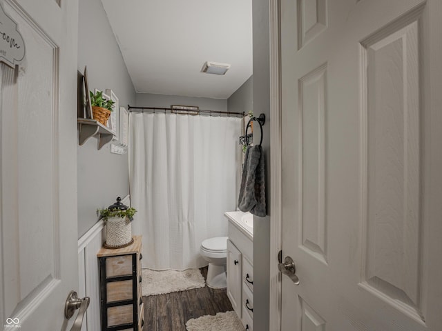 632 Woodside Ct, Seymour, IN 47274 - full bath featuring vanity, curtained shower, wood finished floors, toilet, and a wainscoted wall