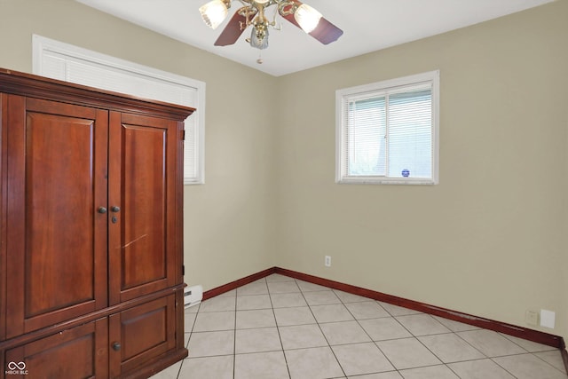 5027 E 40th St, Indianapolis, IN 46226 - unfurnished bedroom featuring baseboards, a baseboard radiator, and ceiling fan