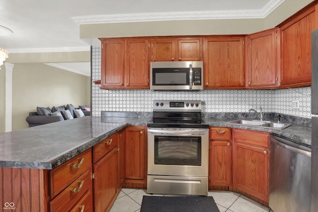 5027 E 40th St, Indianapolis, IN 46226 - kitchen with stainless steel appliances, a sink, ornamental molding, dark countertops, and light tile patterned floors