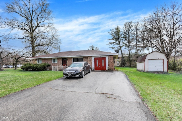 5027 E 40th St, Indianapolis, IN 46226 - single story home featuring asphalt driveway, brick siding, a front lawn, an outdoor structure, and a garage