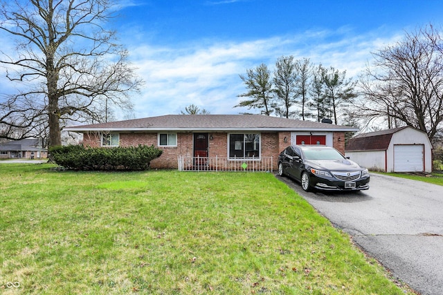 5027 E 40th St, Indianapolis, IN 46226 - single story home with brick siding, an outbuilding, a front lawn, a detached garage, and roof with shingles