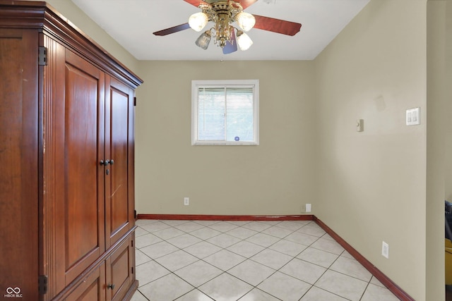 5027 E 40th St, Indianapolis, IN 46226 - unfurnished bedroom with baseboards, light tile patterned floors, and a ceiling fan