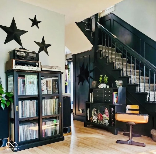 bar with wood finished floors and stairway