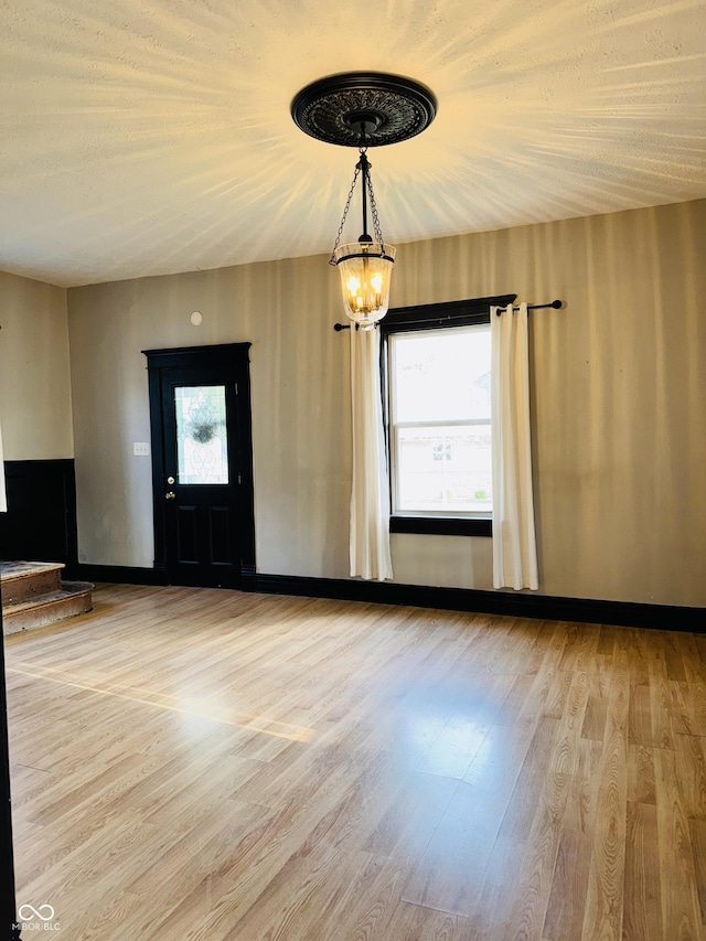 interior space featuring an inviting chandelier and wood finished floors