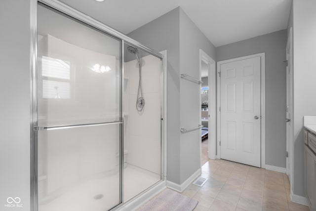 bathroom with vanity, baseboards, and a shower stall