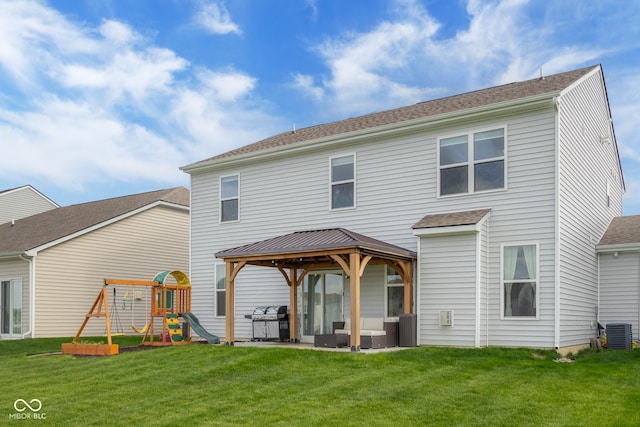 rear view of house featuring central air condition unit, a playground, a gazebo, and a lawn