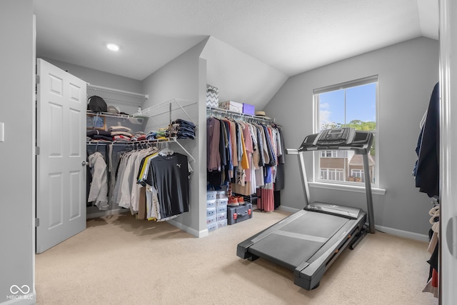 spacious closet with carpet floors and lofted ceiling