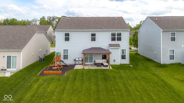 back of house with a lawn, central AC unit, a gazebo, a playground, and a patio