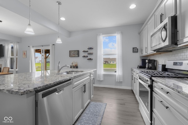 kitchen with recessed lighting, a sink, a wealth of natural light, and stainless steel appliances
