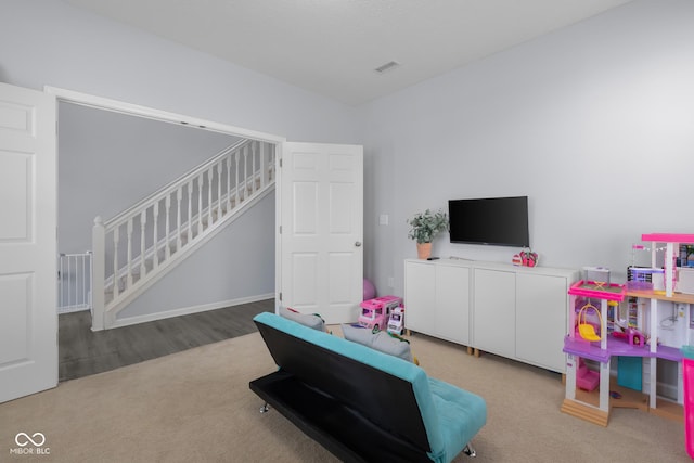 recreation room with carpet flooring and visible vents