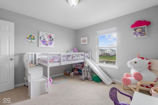 bedroom with baseboards and carpet
