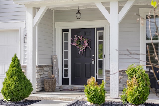 property entrance featuring a porch and stone siding