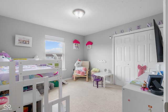 bedroom featuring light carpet and a closet
