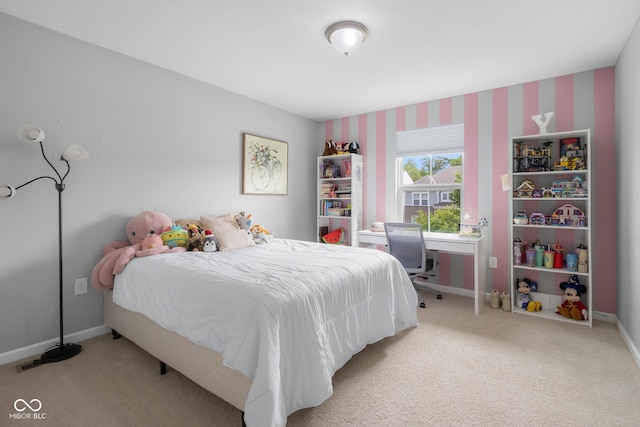 bedroom with baseboards and carpet