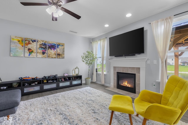 living room featuring visible vents, wood finished floors, a fireplace, recessed lighting, and a ceiling fan