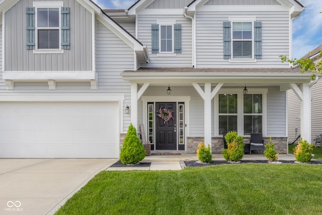 craftsman-style house featuring a front lawn, an attached garage, board and batten siding, a porch, and driveway