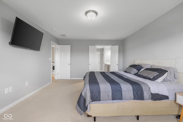 bedroom with baseboards, connected bathroom, and carpet floors