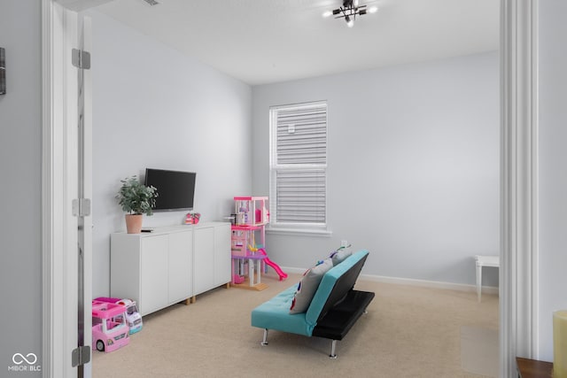 recreation room with carpet flooring and baseboards