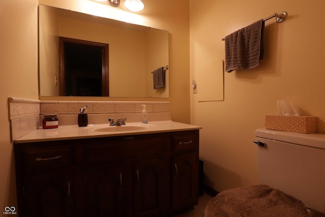 9903 E Raymond St, Indianapolis, IN 46239 - bathroom featuring vanity, backsplash, and toilet