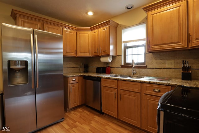 9903 E Raymond St, Indianapolis, IN 46239 - kitchen with a sink, tasteful backsplash, stainless steel appliances, and light wood-style flooring