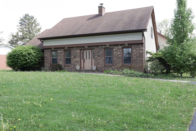 9903 E Raymond St, Indianapolis, IN 46239 - view of front of home featuring brick siding, a chimney, a shingled roof, and a front yard