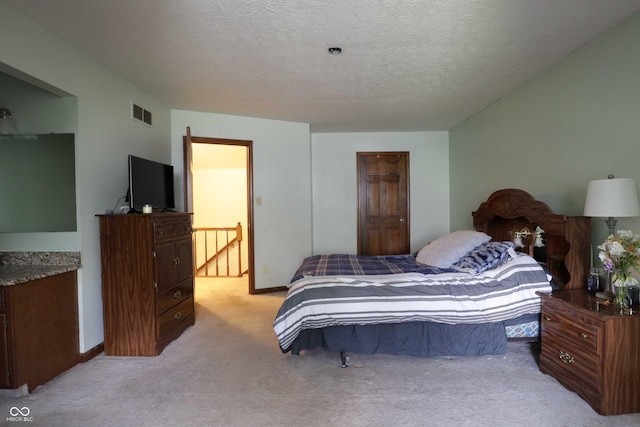 9903 E Raymond St, Indianapolis, IN 46239 - bedroom with baseboards, light carpet, a textured ceiling, and visible vents