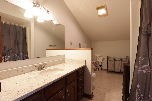 9903 E Raymond St, Indianapolis, IN 46239 - full bath featuring vanity, tile patterned flooring, lofted ceiling, toilet, and baseboards
