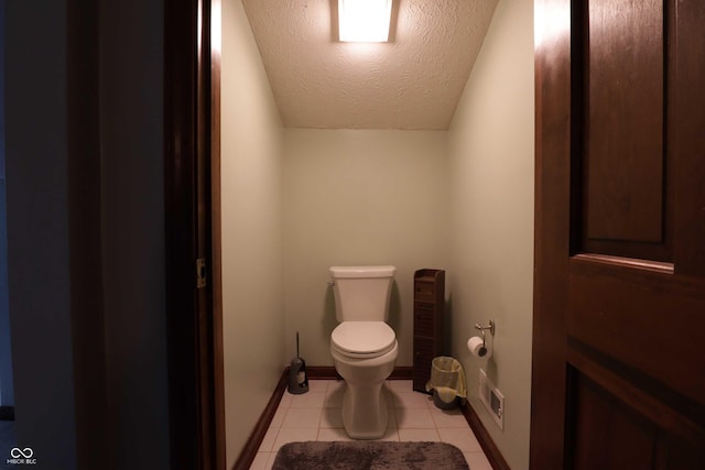 9903 E Raymond St, Indianapolis, IN 46239 - half bath featuring a textured ceiling, visible vents, tile patterned floors, baseboards, and toilet