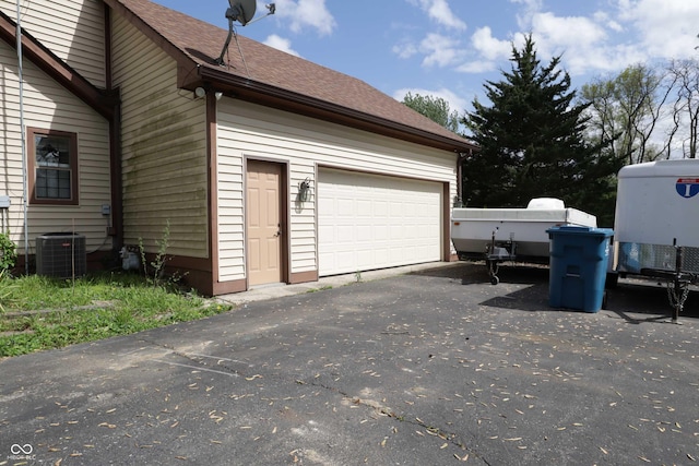9903 E Raymond St, Indianapolis, IN 46239 - garage with cooling unit and aphalt driveway