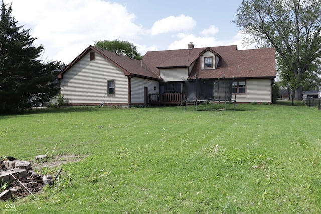 9903 E Raymond St, Indianapolis, IN 46239 - back of house featuring a lawn, a chimney, and a trampoline