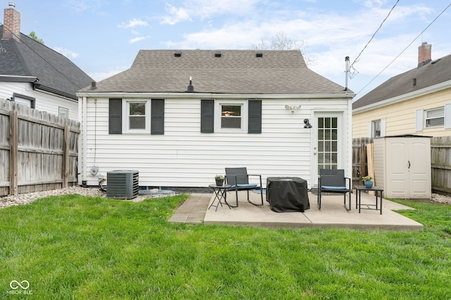 back of house with a yard, cooling unit, a fenced backyard, and a patio area