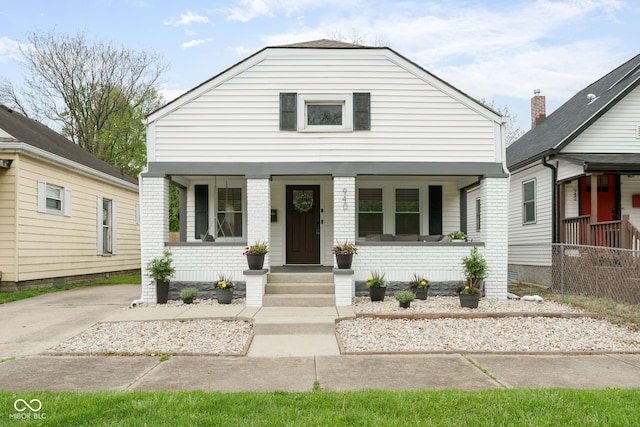 view of front of home with a porch and fence