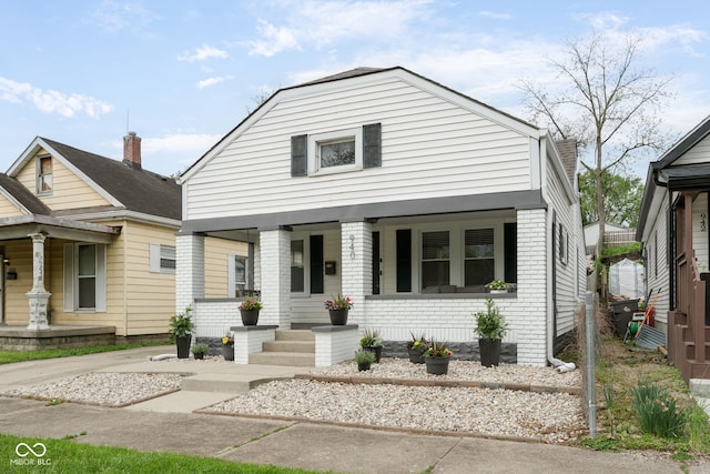 view of front of property with brick siding and covered porch