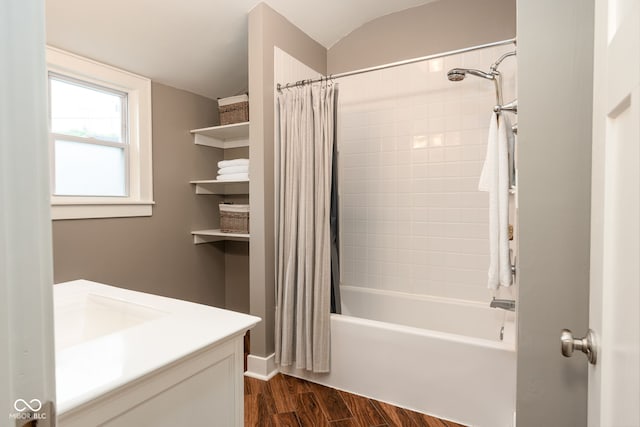 full bath with lofted ceiling, wood finished floors, shower / bath combo, and vanity