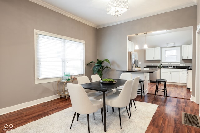 dining room featuring crown molding, a chandelier, visible vents, and a healthy amount of sunlight