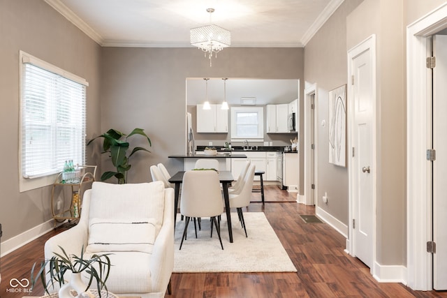dining room with crown molding, dark wood finished floors, and baseboards