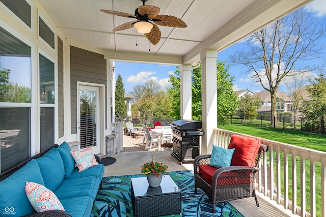 wooden terrace with an outdoor hangout area, a grill, and a ceiling fan