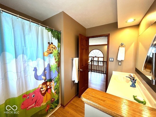 bathroom with wood finished floors, baseboards, vanity, recessed lighting, and a shower with shower curtain